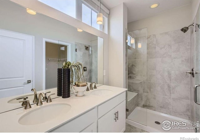 921 Abbott Ln, Fort Collins, CO 80524 - full bathroom featuring a shower stall, double vanity, a spacious closet, and recessed lighting