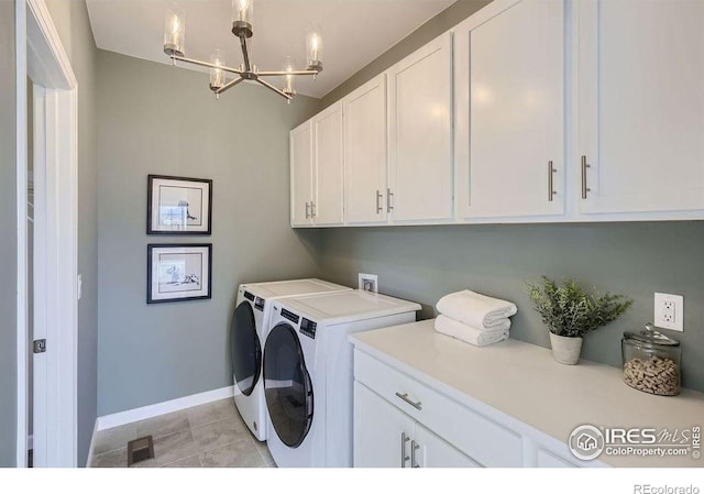 921 Abbott Ln, Fort Collins, CO 80524 - laundry area with cabinet space, separate washer and dryer, a chandelier, and light tile patterned flooring