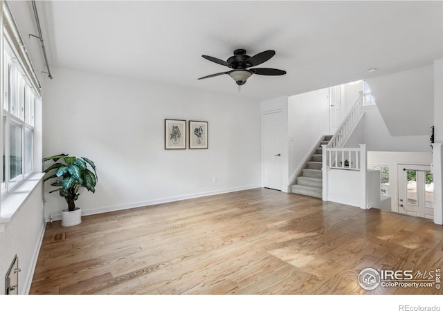 1993 S Fork Dr, Lafayette, CO 80026 - unfurnished living room with ceiling fan, wood finished floors, stairway, and french doors