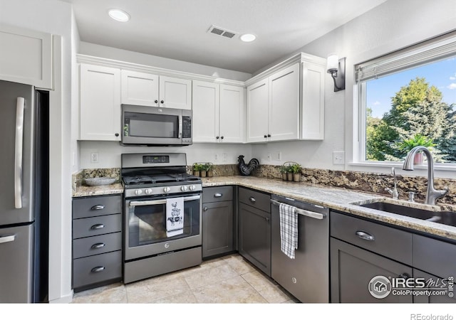 1993 S Fork Dr, Lafayette, CO 80026 - kitchen featuring stainless steel appliances, white cabinetry, light stone counters, and recessed lighting