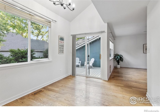 1993 S Fork Dr, Lafayette, CO 80026 - unfurnished room with a chandelier, wood finished floors, and lofted ceiling