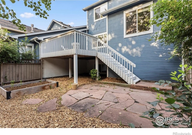 1993 S Fork Dr, Lafayette, CO 80026 - rear view of property featuring a vegetable garden, stairs, a patio, and a deck