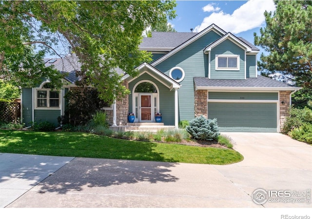388 Fairfield Ln, Louisville, CO 80027 - view of front of home with stone siding, a garage, driveway, a front yard, and a shingled roof