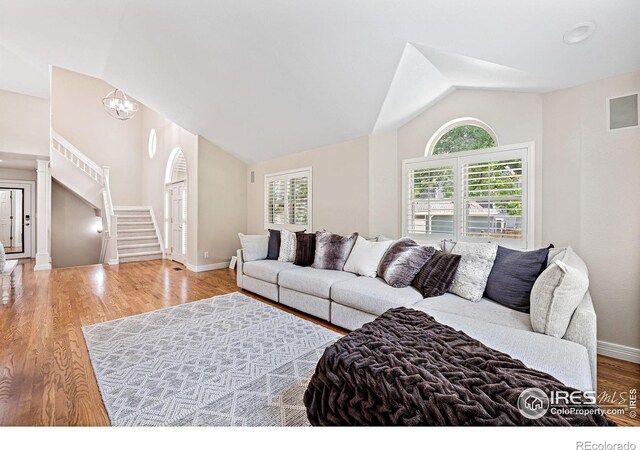 388 Fairfield Ln, Louisville, CO 80027 - living area with lofted ceiling, stairway, wood finished floors, and a chandelier