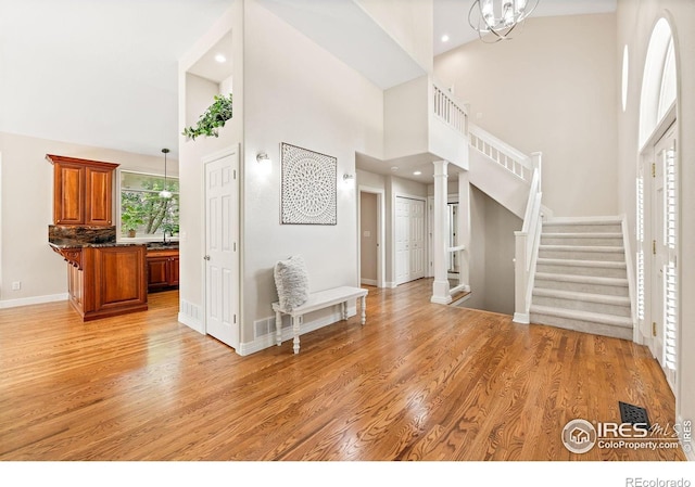 388 Fairfield Ln, Louisville, CO 80027 - entrance foyer featuring a towering ceiling, light wood-style flooring, stairs, decorative columns, and recessed lighting