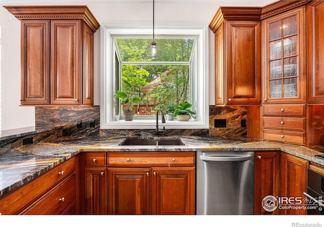 388 Fairfield Ln, Louisville, CO 80027 - kitchen with stainless steel dishwasher, tasteful backsplash, brown cabinetry, decorative light fixtures, and glass insert cabinets