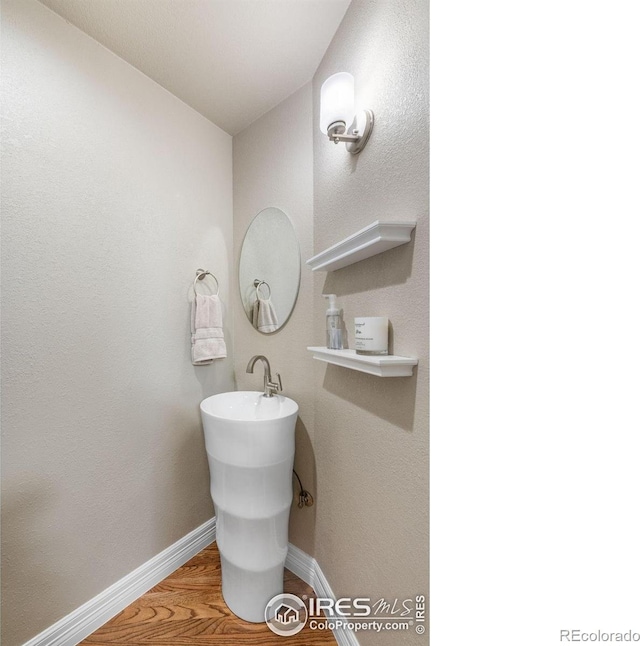 388 Fairfield Ln, Louisville, CO 80027 - bathroom featuring baseboards and wood finished floors