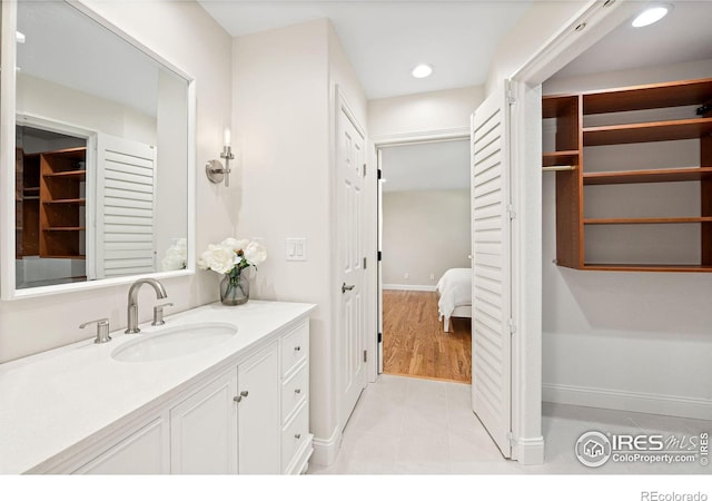 388 Fairfield Ln, Louisville, CO 80027 - bathroom with vanity, a closet, connected bathroom, and recessed lighting