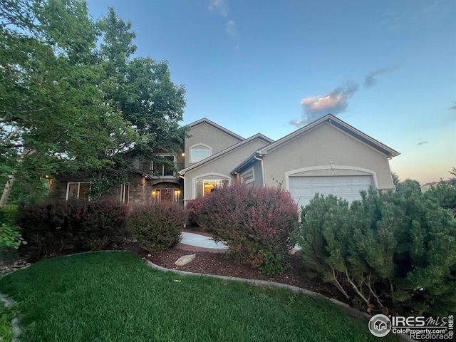 1402 Westfield Dr, Fort Collins, CO 80526 - view of front of house featuring an attached garage, stucco siding, and a front yard