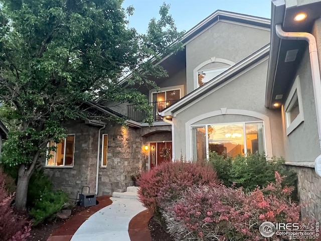 1402 Westfield Dr, Fort Collins, CO 80526 - view of front of house with a balcony, stucco siding, and stone siding