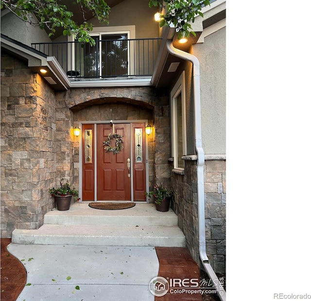 1402 Westfield Dr, Fort Collins, CO 80526 - entrance to property featuring stone siding, stucco siding, and a balcony