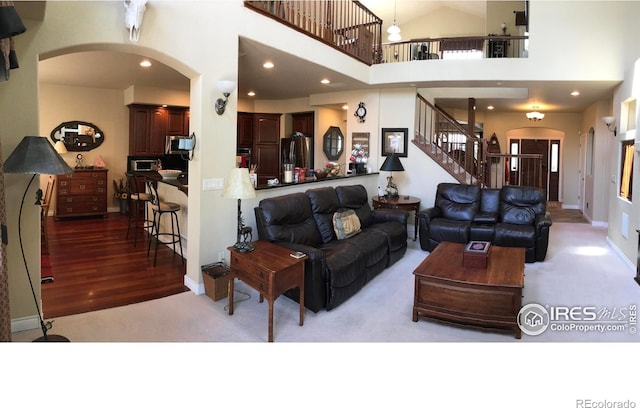 1402 Westfield Dr, Fort Collins, CO 80526 - living area featuring arched walkways, carpet flooring, stairway, and recessed lighting