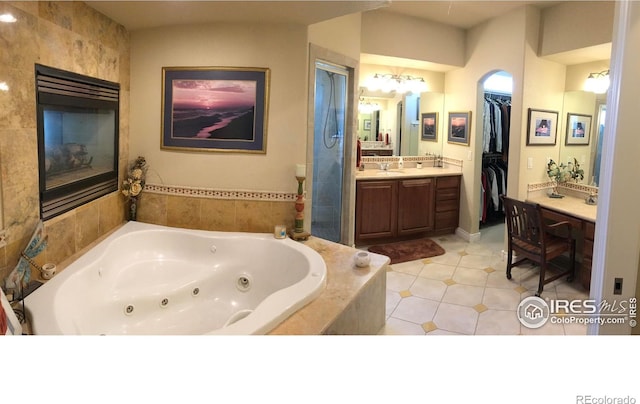 1402 Westfield Dr, Fort Collins, CO 80526 - bathroom featuring vanity, a jetted tub, tile patterned flooring, and a spacious closet