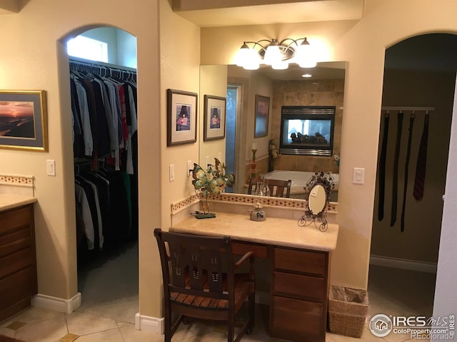 1402 Westfield Dr, Fort Collins, CO 80526 - bathroom featuring vanity, tile patterned floors, a spacious closet, and a bath