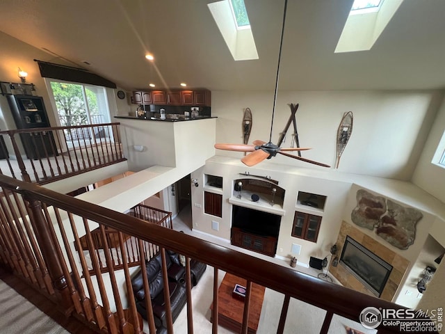 1402 Westfield Dr, Fort Collins, CO 80526 - staircase featuring a skylight, a glass covered fireplace, and vaulted ceiling