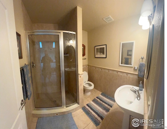 1402 Westfield Dr, Fort Collins, CO 80526 - bathroom with a shower stall, tile patterned floors, tile walls, and wainscoting