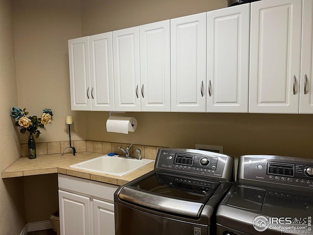 1402 Westfield Dr, Fort Collins, CO 80526 - washroom featuring washing machine and clothes dryer and cabinet space