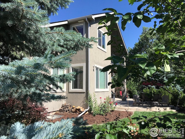 1402 Westfield Dr, Fort Collins, CO 80526 - view of side of property with stucco siding and a patio
