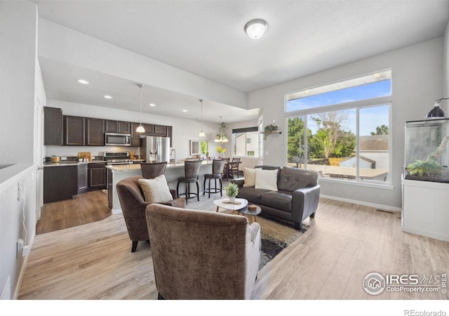 660 Cimarron Trl, Ault, CO 80610 - living room with light wood-style floors and recessed lighting