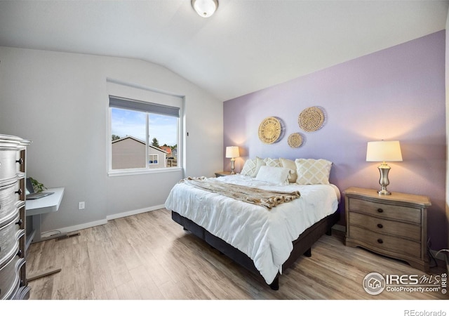 660 Cimarron Trl, Ault, CO 80610 - bedroom with wood finished floors and vaulted ceiling