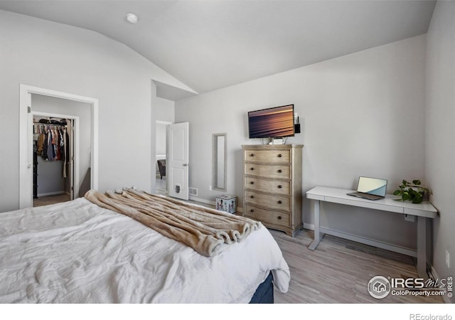 660 Cimarron Trl, Ault, CO 80610 - bedroom featuring lofted ceiling, light wood-style floors, and a spacious closet