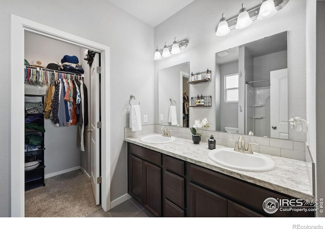 660 Cimarron Trl, Ault, CO 80610 - full bathroom with double vanity, a shower, a walk in closet, and tile patterned flooring
