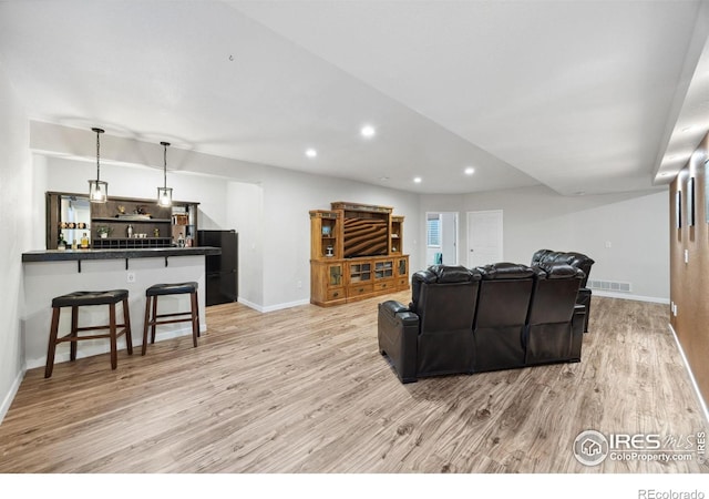 660 Cimarron Trl, Ault, CO 80610 - living area featuring light wood-style flooring, bar area, and recessed lighting