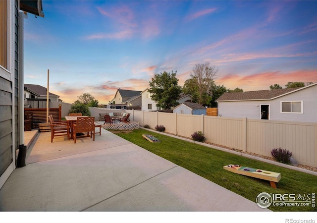 660 Cimarron Trl, Ault, CO 80610 - patio terrace at dusk with a patio area, a fenced backyard, and outdoor dining space