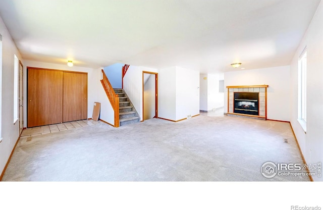 2027 Churchill Ct, Fort Collins, CO 80526 - unfurnished living room with stairway, light colored carpet, and a fireplace