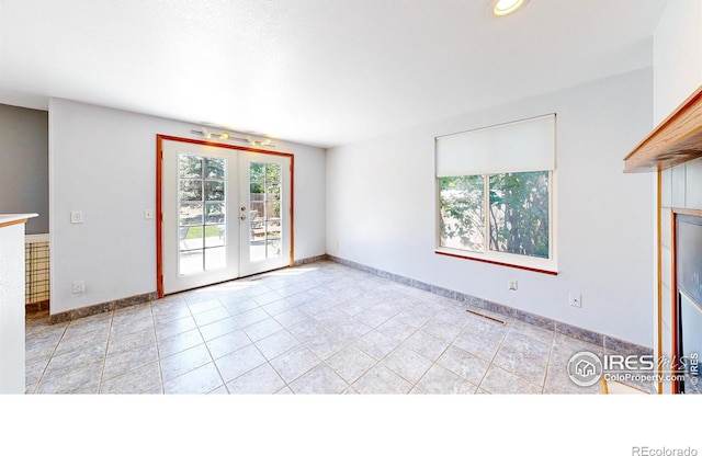 2027 Churchill Ct, Fort Collins, CO 80526 - unfurnished living room with french doors, light tile patterned floors, and recessed lighting