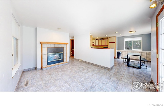 2027 Churchill Ct, Fort Collins, CO 80526 - unfurnished living room with a tiled fireplace and recessed lighting