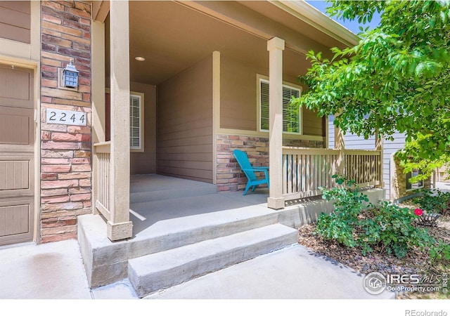 2244 Woodbury Ln, Fort Collins, CO 80524 - property entrance featuring a porch and stone siding
