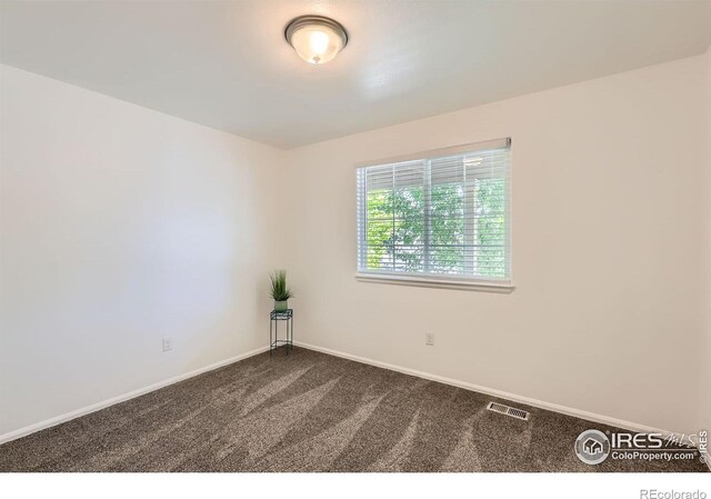 2244 Woodbury Ln, Fort Collins, CO 80524 - unfurnished room with dark carpet and baseboards