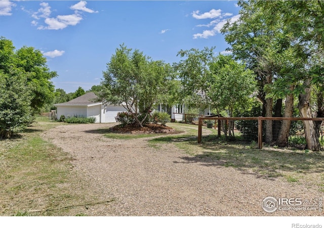 4223 Eldorado Springs Dr, Boulder, CO 80303 - view of front of house with dirt driveway and a garage