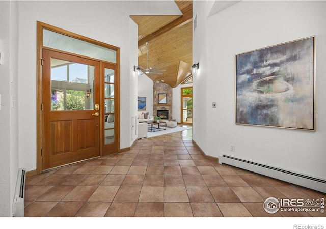 4223 Eldorado Springs Dr, Boulder, CO 80303 - tiled entryway with a baseboard radiator, baseboard heating, a stone fireplace, plenty of natural light, and beamed ceiling