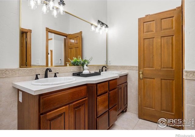 4223 Eldorado Springs Dr, Boulder, CO 80303 - bathroom featuring tile walls, double vanity, tile patterned flooring, and a wainscoted wall