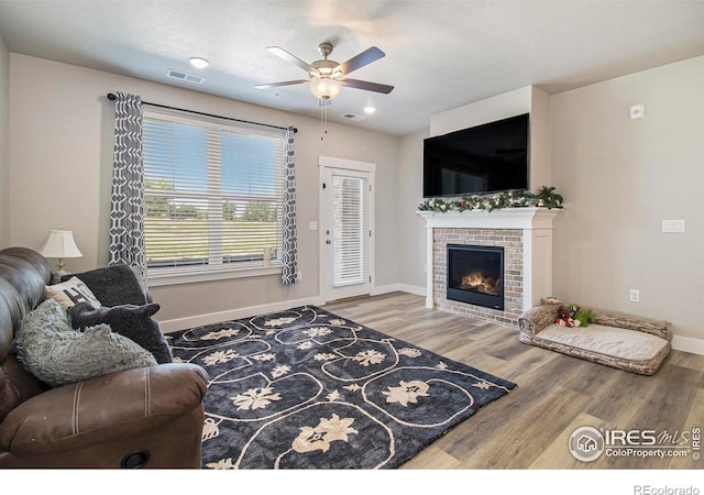 285 High Point Dr Unit H-104, Longmont, CO 80504 - living area with a ceiling fan, wood finished floors, and a fireplace