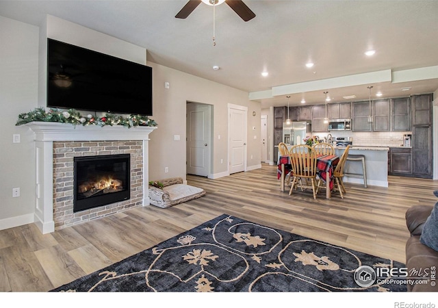285 High Point Dr Unit H-104, Longmont, CO 80504 - living area with a ceiling fan, light wood finished floors, a fireplace, and recessed lighting