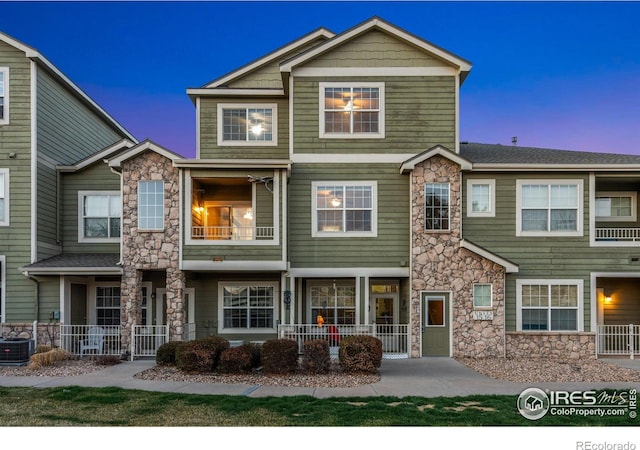6925 19th St Unit 15, Greeley, CO 80634 - view of front of house with stone siding and a patio area