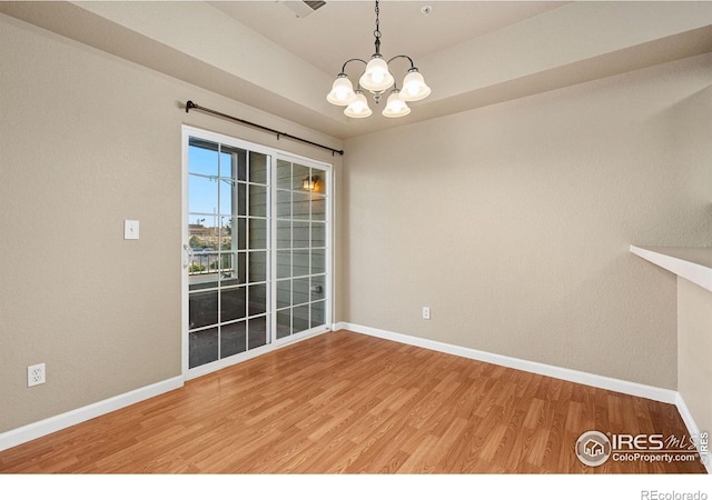 6925 19th St Unit 15, Greeley, CO 80634 - empty room featuring light wood-style flooring and a chandelier