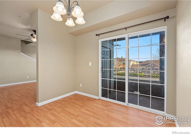 6925 19th St Unit 15, Greeley, CO 80634 - unfurnished room featuring ceiling fan, a chandelier, and wood finished floors
