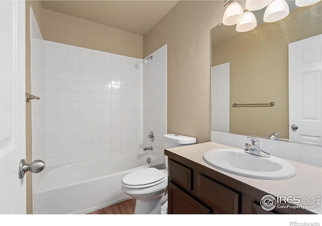 6925 19th St Unit 15, Greeley, CO 80634 - full bathroom with vanity, a textured wall, wood finished floors, and shower / bath combination