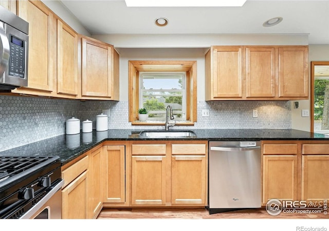 775 Pleasant St, Boulder, CO 80302 - kitchen with stainless steel appliances, light brown cabinets, dark stone countertops, recessed lighting, and backsplash