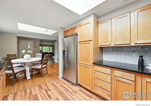 775 Pleasant St, Boulder, CO 80302 - kitchen featuring stainless steel fridge, a skylight, light wood-type flooring, tasteful backsplash, and light brown cabinets
