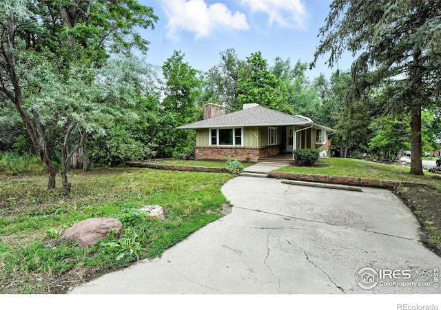 775 Pleasant St, Boulder, CO 80302 - view of front of home featuring covered porch, a chimney, a front yard, and driveway