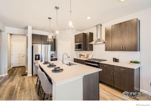 2290 Walbridge Rd, Fort Collins, CO 80524 - kitchen with wall chimney range hood, appliances with stainless steel finishes, dark brown cabinets, light countertops, and recessed lighting
