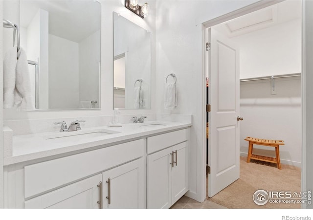 9873 Ceylon St, Commerce City, CO 80022 - bathroom featuring double vanity and a walk in closet