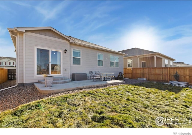 9873 Ceylon St, Commerce City, CO 80022 - rear view of house featuring a patio area, a fenced backyard, and entry steps