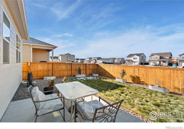9873 Ceylon St, Commerce City, CO 80022 - fenced backyard with a residential view, outdoor dining area, and a patio area