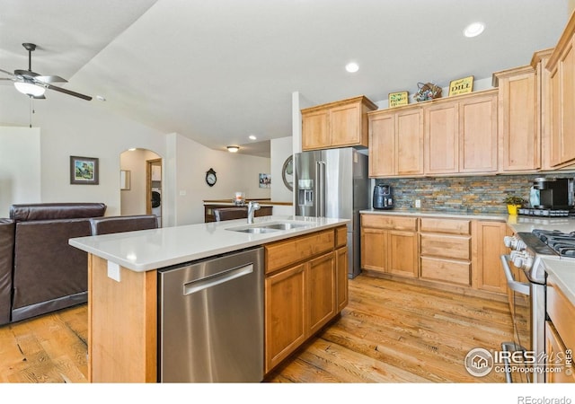 1613 Alpine Ave, Berthoud, CO 80513 - kitchen with stainless steel appliances, ceiling fan, open floor plan, arched walkways, and light wood-style flooring